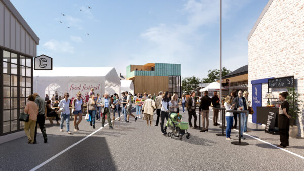 Architectural visualisation of the Stockyard development, showing a busy pedestrianised street lined with shops and a gin bar, a marquee hosting a food festival, and a striking timber-and-green-tiled building at the centre, with crowds of people walking, shopping, and socialising at outdoor tables.